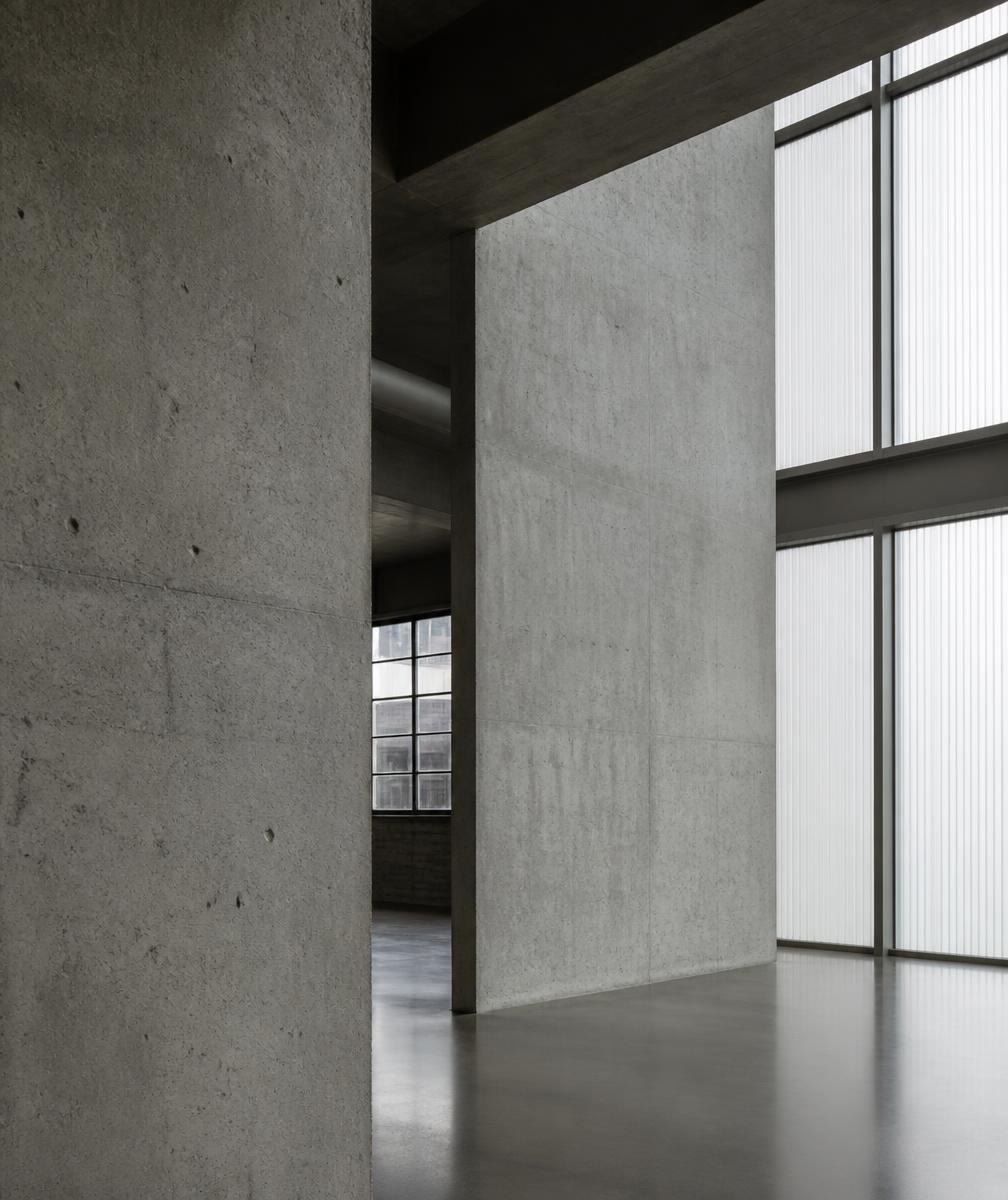 Concrete and glass interior of a light-filled industrial archive